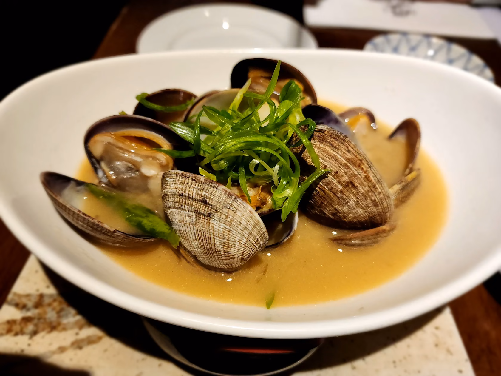 Clams in broth with scallions